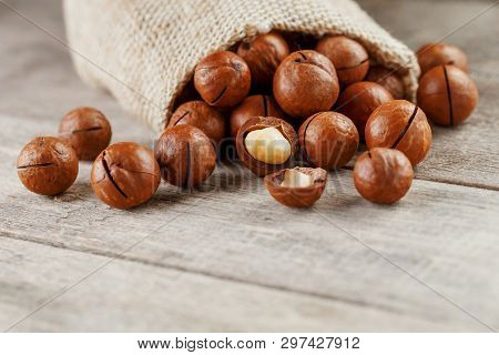 Macadamia Nut On A Wooden Table In A Bag, Closeup, Top View