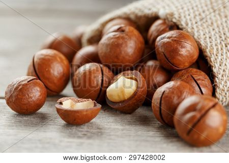 Macadamia Nut On A Wooden Table In A Bag, Closeup, Top View