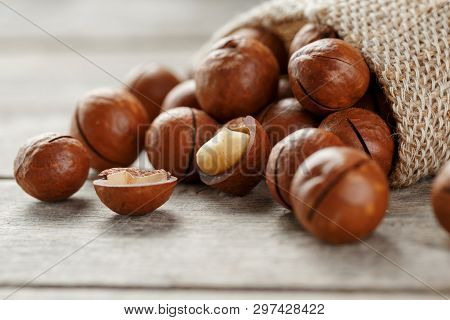 Macadamia Nut On A Wooden Table In A Bag, Closeup, Top View