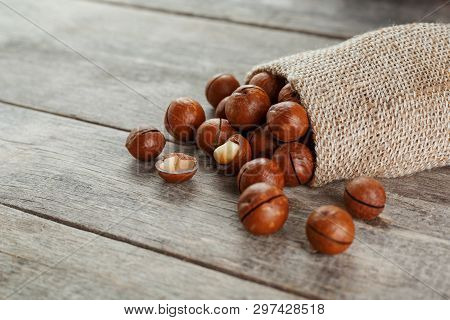 Macadamia Nut On A Wooden Table In A Bag, Closeup, Top View