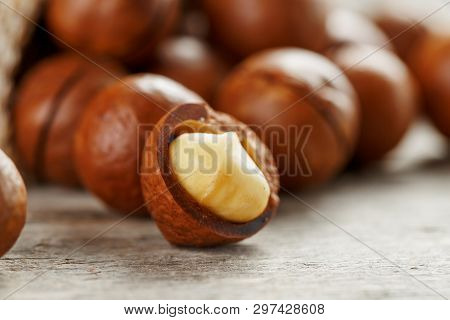 Macadamia Nut On A Wooden Table In A Bag, Closeup, Top View