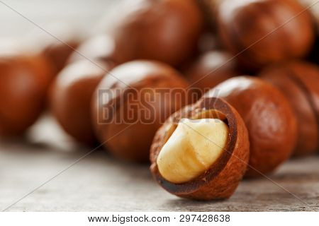 Macadamia Nut On A Wooden Table In A Bag, Closeup, Top View