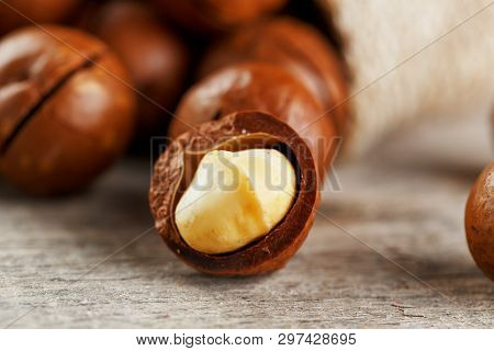 Macadamia Nut On A Wooden Table In A Bag, Closeup, Top View