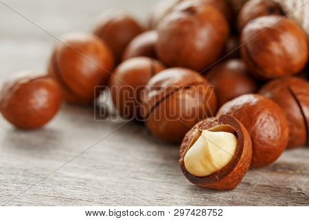 Macadamia Nut On A Wooden Table In A Bag, Closeup, Top View