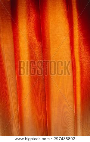 Vertical Folds On Orange Organza Curtains For Background And Design