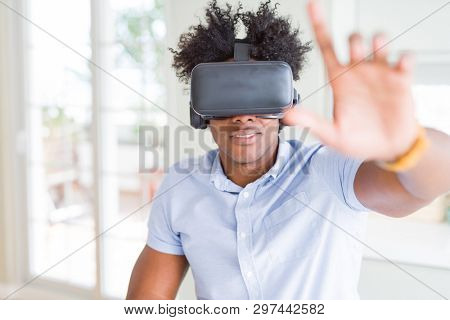 African amaerican man having fun playing with virtual reality glasses