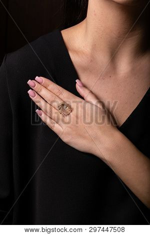 Womens Ring Of Rose Gold In The Form Of A Shell With A Pearl Of Stone  On The Finger, On A Black Bac