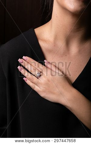 Womens Silver Ring With Stones In The Middle In The Shape Of A Square On The Finger, On A Black Back