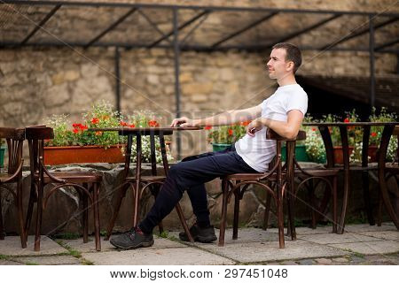 Happy Man Having Coffee Break At Outdoors Cafe In Old Europen City