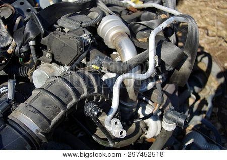 Old And Rusty Car Parts Like Brake Discs,axles And Engines.