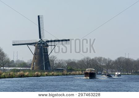 Waterways Of North Holland With Boats And View On Traditional Dutch Mill, Spring Landscape