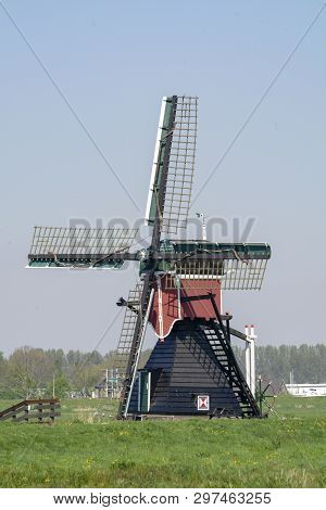 View On Traditional Dutch Wind Mill, Spring Landscape In North Holland, The Netherlands