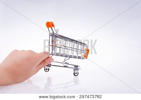 Hand Holding A Cart On A White Background