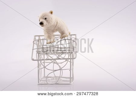 Polar Bear Cub On The Roof Of A Model House Mado Of Roof