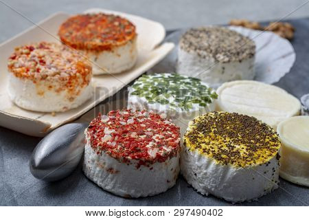 Assortment Of French Fresh White Soft Goat Cheeses With Different Tastes Topping Made With Herbs, Pa