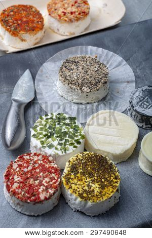 Assortment Of French Fresh White Soft Goat Cheeses With Different Tastes Topping Made With Herbs, Pa