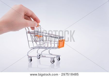 Hand Holding A Cart On A White Background