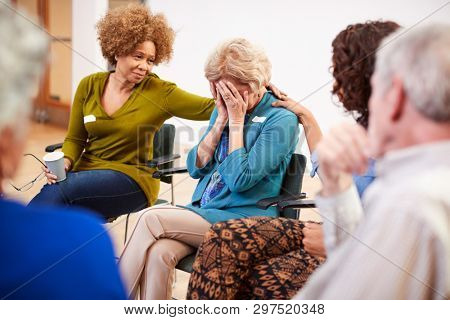 Unhappy Woman Attending Self Help Therapy Group Meeting In Community Center