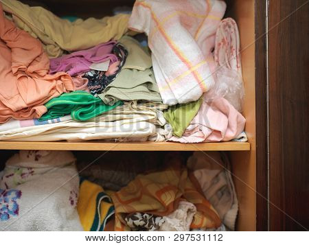 Crumpled Linen And Towels On A Shelf Of Closet In Complete Mess, Indoors Close-up