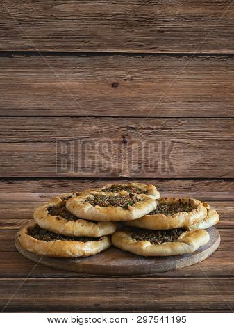 Arabic Meat Sfiha Over A Wooden Table