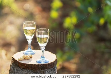 Two Glasses Of Fresh White Wine On A Wooden Board A Traditional Italian Snack - Taralli On A Bright 