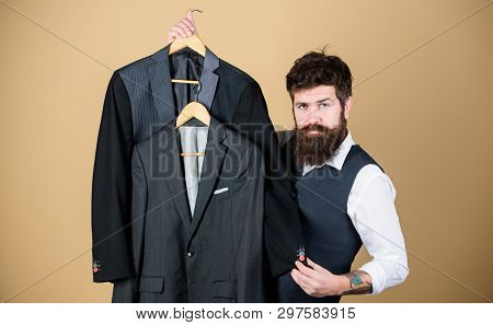 Dashing Mens Fashion And Style. Fashion Designer Helping To Choose Suit Jacket. Fashion Stylist Hold