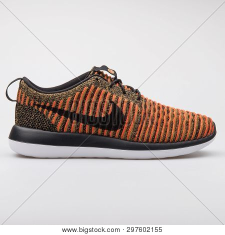 Vienna, Austria - August 7, 2017: Nike Roshe Two Flyknit Black And Orange Sneaker On White Backgroun