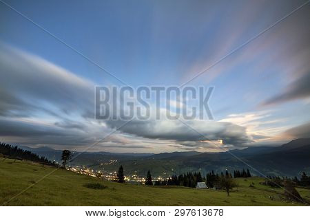 Summer Night Mountain Panorama. Green Grassy Mountain Clearing, Spruce Trees On Blue Evening Sky Cop