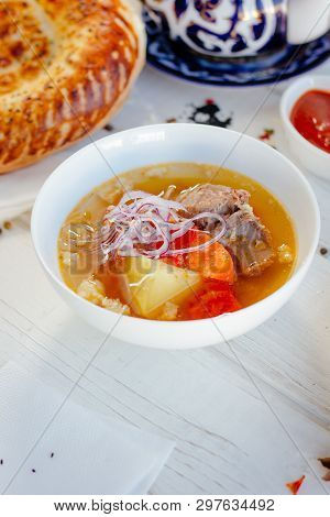 Uzbek Chorba - Soup From Fresh Meat And Vegetables On White Table, Great Image For Your Needs.
