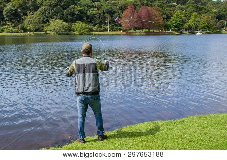 Flyfishing On The Lake In Brazil, Young Fisherman Fishing.