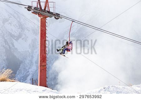 Dombai, Russia - January 3, 2014: People Are Lifting On Open Lft High Up In Caucasus Mountains