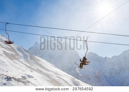 Dombai, Russia - January 3, 2014: People Are Lifting On Open Lft High Up In Caucasus Mountains