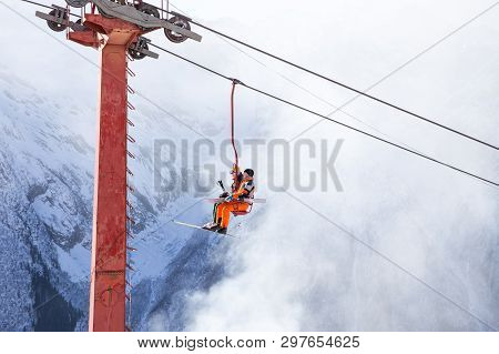 Dombai, Russia - January 3, 2014: People Are Lifting On Open Lft High Up In Caucasus Mountains