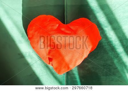 Heart Shaped Small Decorative Pillow On Soft Green Pouffe. Modern Interior Cozy Design Element