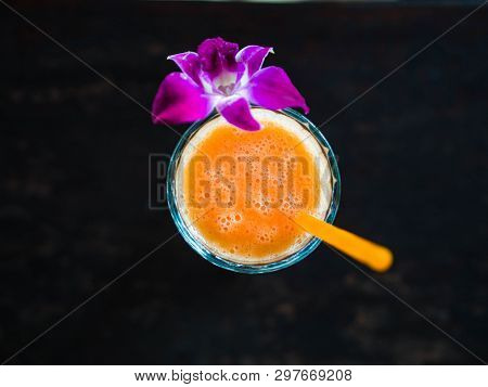 Freshly Made Multi Fruit Orange Smoothie From Various Tropical Fruits In A Glass Beaker Decorated Wi