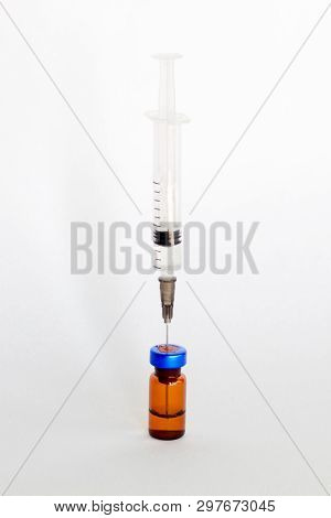 Medical Vial, Ampule For Injection With A Syringe On A White Background