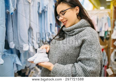 Happy future mother buys childrens clothes