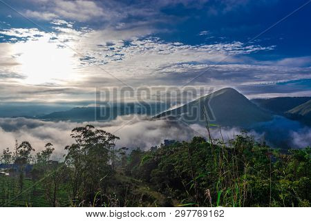 Forest View Form Top Of The Hill With Hill, Low White Cloud And Blue Sky.