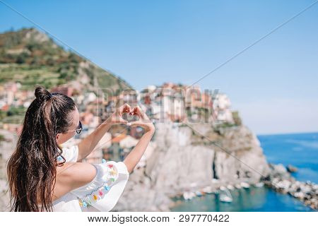 Happy Girl Making With Hands Heart Shape On The Old Coastal Village In Cinque Terre National Park. E