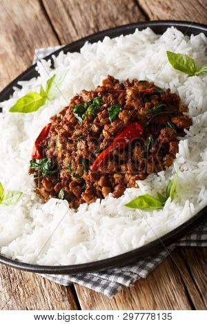Thai Basil Chicken (gai Pad Krapow) With Rice Close-up On A Plate. Vertical