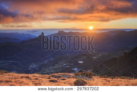 Sunset Over Gran Canaria, Spain. The Roque Nublo Is Visible On The Left Side. Tenerife Is Visible In
