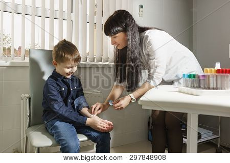 The Nurse Rubs The Boys Hand To Test The Mantoux Test , Which Is Aimed At Identifying The Presence O