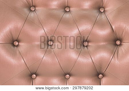 Pink Soft Leatherette Background With Symmetrical Buttons. Soft And Expensive Furniture Elements. Lu