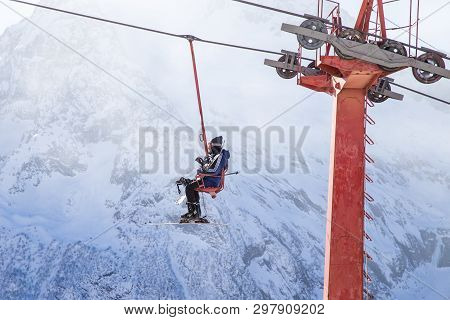 Dombai, Russia - January 3, 2014: People Are Lifting On Open Lft High Up In Caucasus Mountains