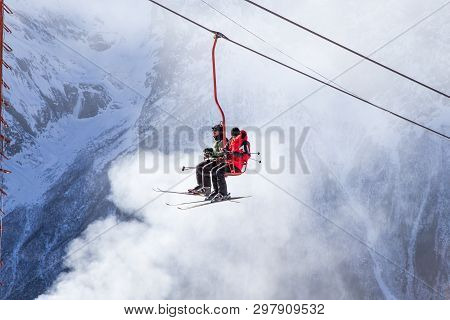 Dombai, Russia - January 3, 2014: People Are Lifting On Open Lft High Up In Caucasus Mountains