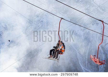 Dombai, Russia - January 3, 2014: People Are Lifting On Open Lft High Up In Caucasus Mountains