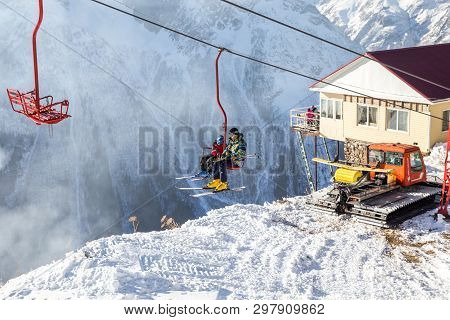 Dombai, Russia - January 3, 2014: People Are Lifting On Open Lft High Up In Caucasus Mountains