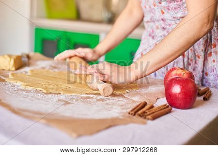 Woman Kneading Dough For The Apple Pie On Kitchen Table. Rustic Style