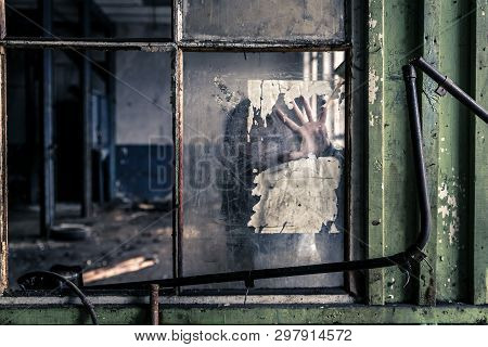 Woman Standing Behind The Window, You Can See Her Hand On The Glass.