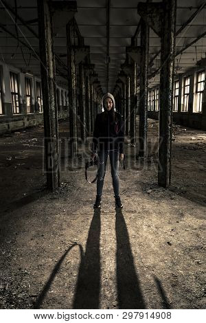 Young Girl Is Standing In Coridor In Old, Ruined Factory.
